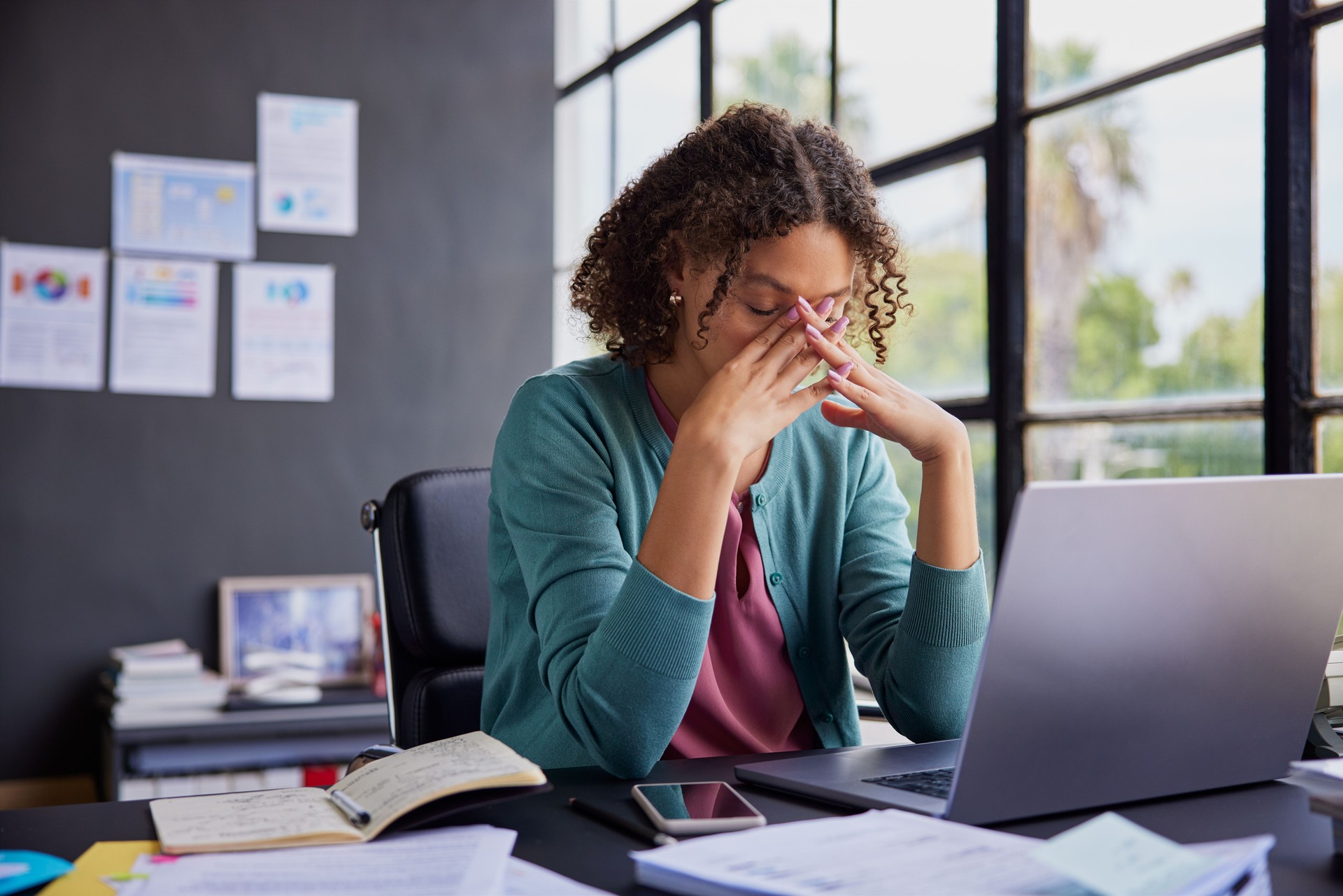 Stressed multiethnic businesswoman at work