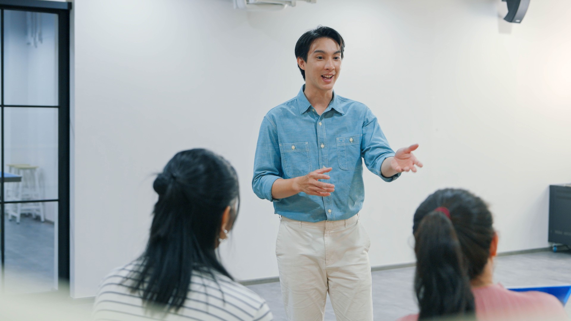 Professional Discussion with a Young Team Leader Motivating Colleagues in a Casual Workspace