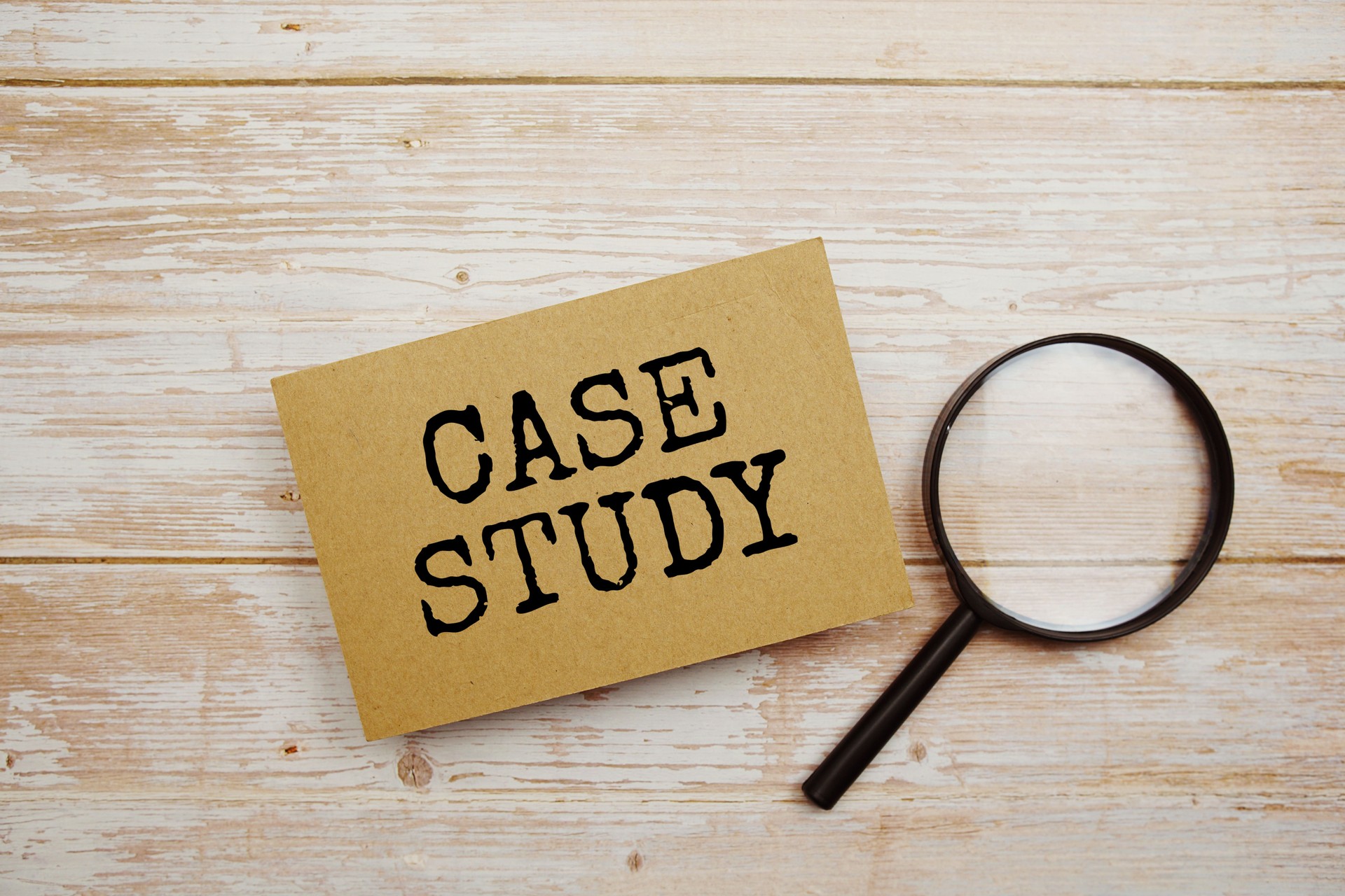Case Study text message and magnifying glass with space copy on wooden background